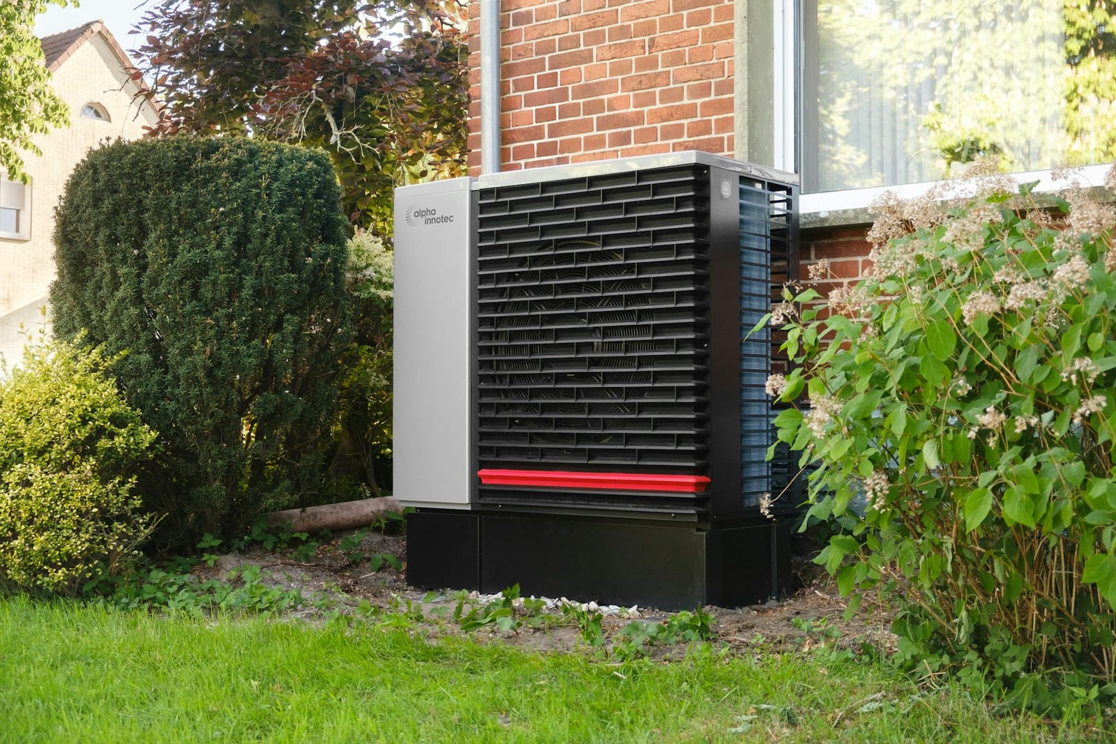Outdoor heat pump unit installed beside a residence